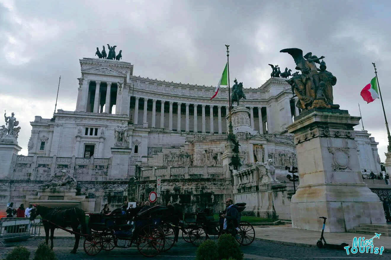 Monumento Vittorio Emanuele II in Rome with statues, Italian flags, and a horse-drawn carriage in front.