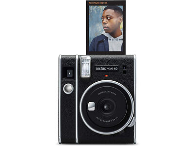 A Fujifilm Instax Mini 40 instant camera with a photo of a person emerging from the top. The camera has a black body with silver accents.