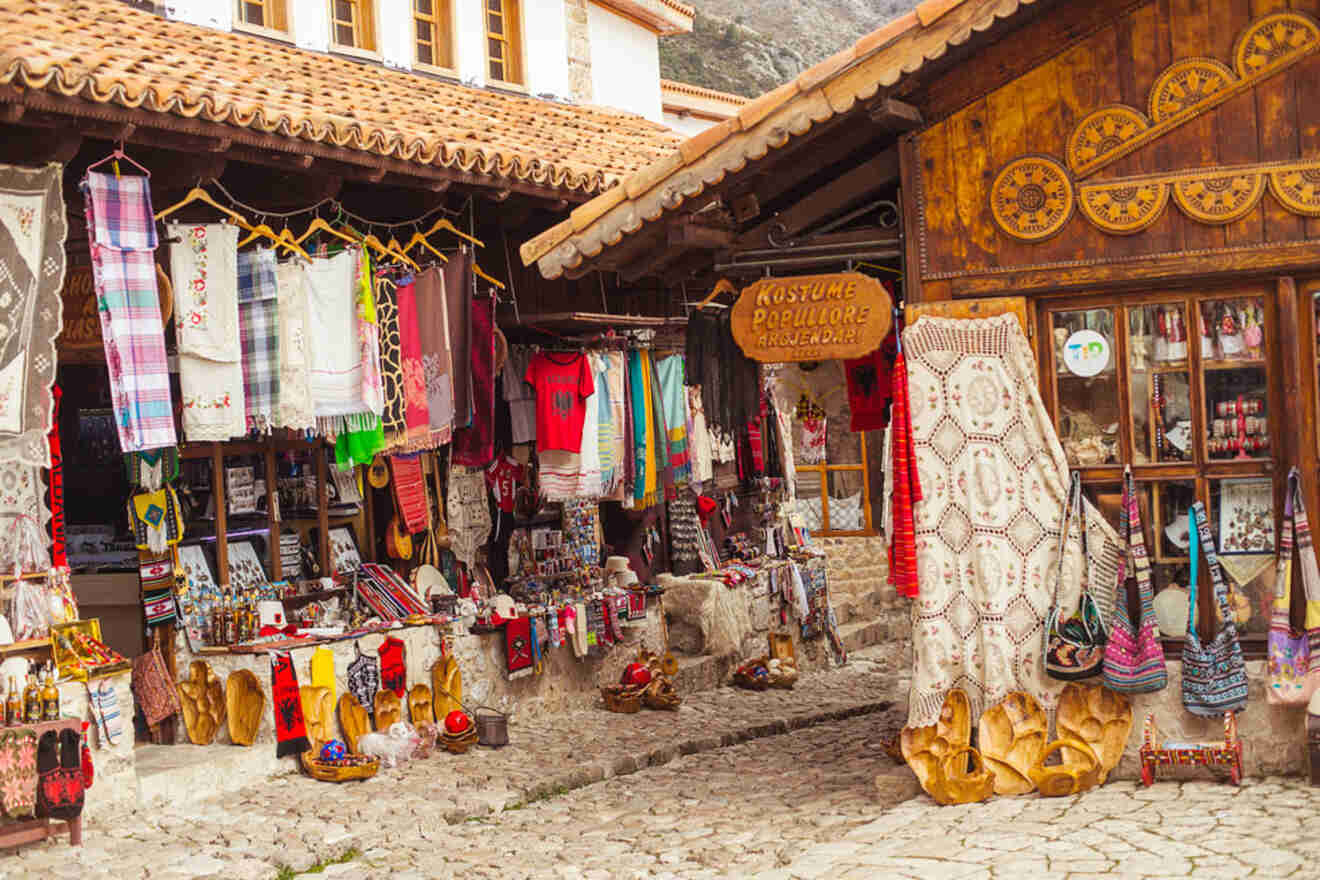 A colorful display of traditional Albanian textiles and souvenirs at Kruje's Old Bazaar.