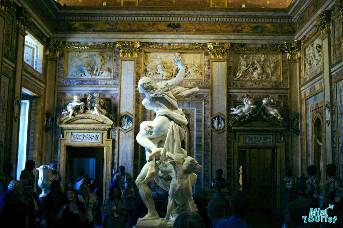 An ornate room in Villa Borghese with intricate statues and frescoed ceilings, filled with visitors.