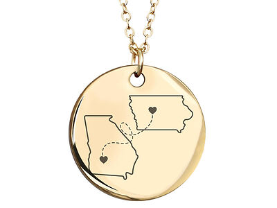 Gold pendant necklace with engraved outlines of two states connected by dotted lines and hearts.