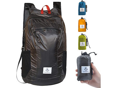 A black foldable backpack with a front pocket is shown. The image also displays three additional color options (blue, orange, and green) along with a hand holding the bag in its compact form.