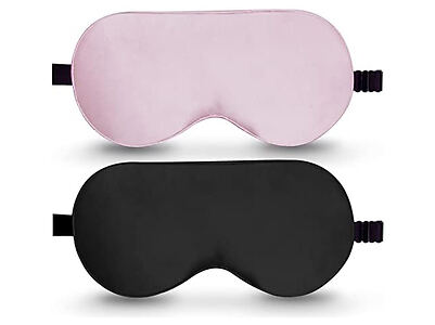 Two sleep masks are shown: one pink and one black. Both have adjustable straps and a soft texture.