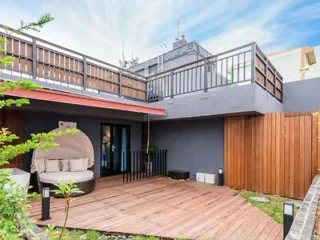 Modern terrace with wooden decking and a lounge chair.