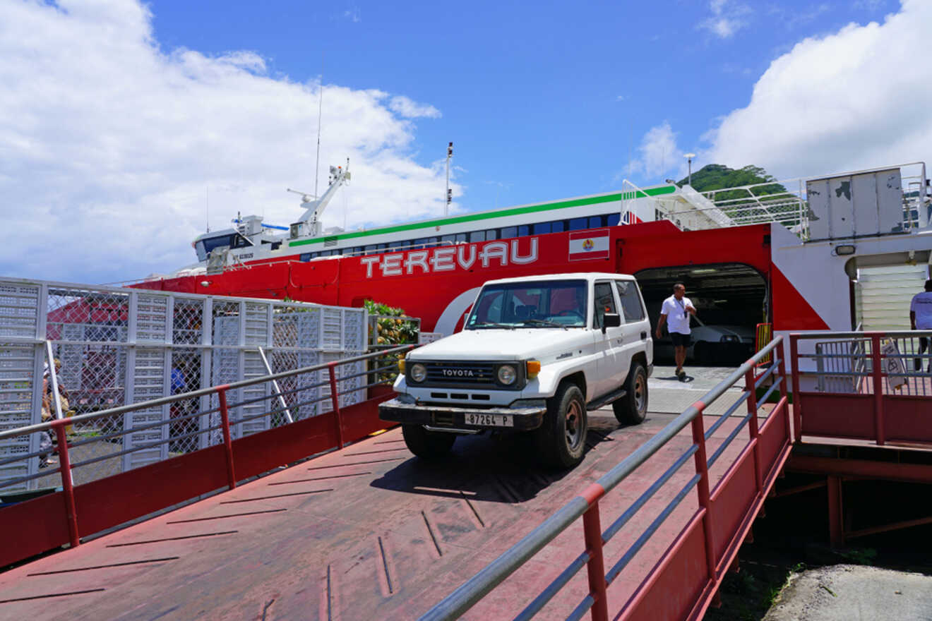 A large wooden ferry terminal building with various loading docks and a clear view of the water.