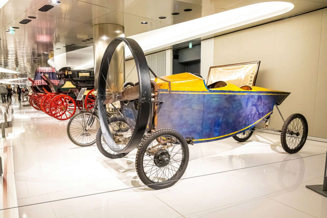 A unique vehicle with a large propeller on display among other vintage cars in the Car Collection of the Prince of Monaco.