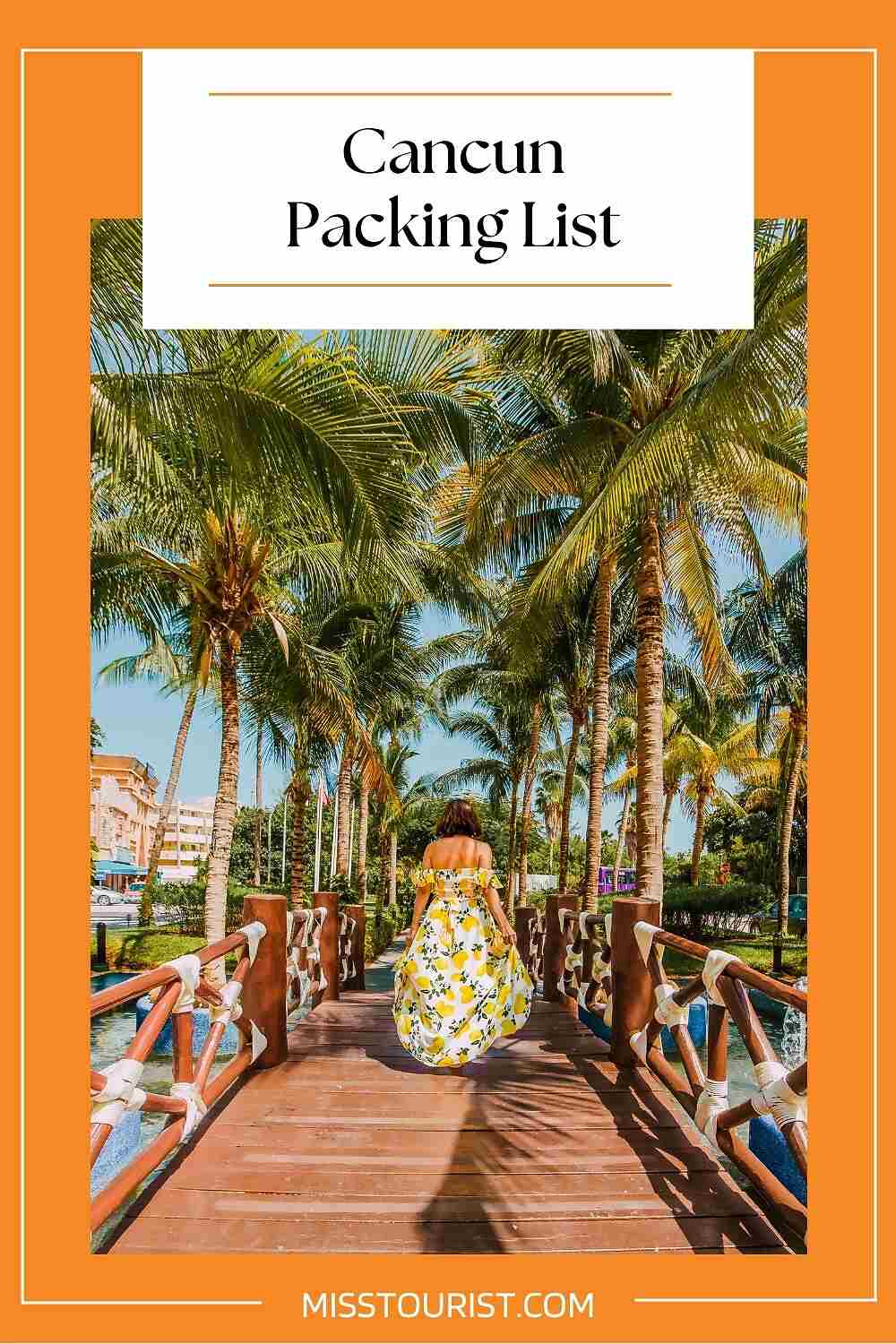 A person in a yellow dress walks on a wooden bridge between palm trees under a sunny sky. Text at the top reads, "Cancun Packing List.