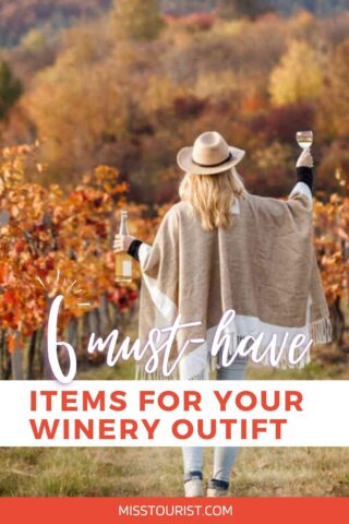 A person wearing a poncho and hat stands in a vineyard holding a wine glass and a bottle with a title, "6 must-have items for your winery outfit.