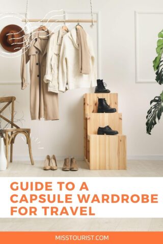 Image showing a stylish travel capsule wardrobe setup with coats, sweaters, shoes, and boots displayed on a hanging rack and wooden boxes. Text reads "Guide to a Capsule Wardrobe for Travel.