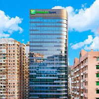 Exterior view of the Holiday Inn Express building, a modern high-rise with glass windows