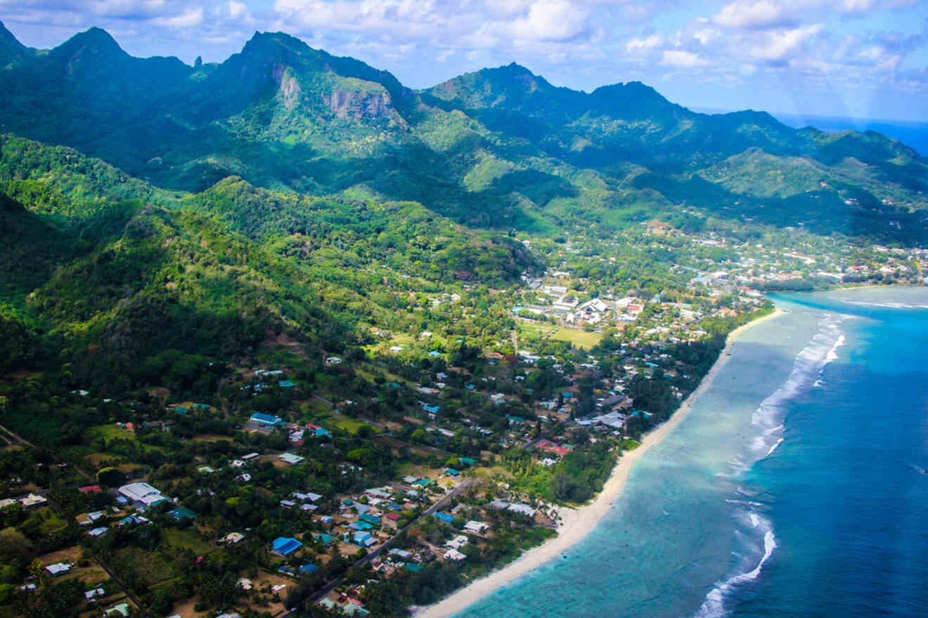 Aerial view of the coastline and lush green mountains of Rarotonga, Cook Islands