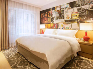 hotel room at the Caravel Hotel featuring a large white bed