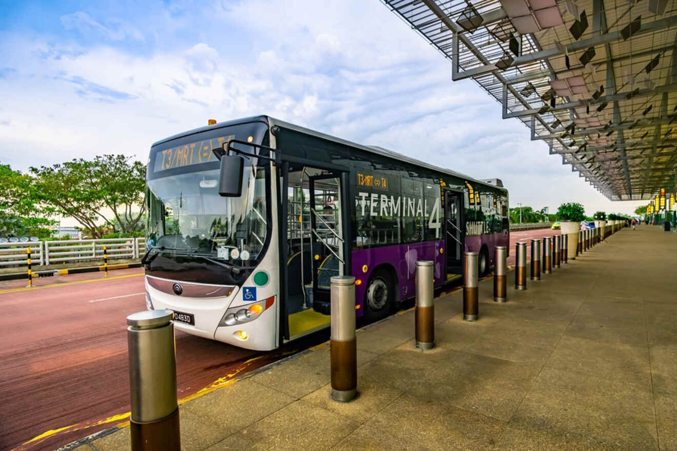 A bus marked "Terminal 4" is parked at a designated area under a shelter. It appears to be at an airport or transportation hub on a clear day.