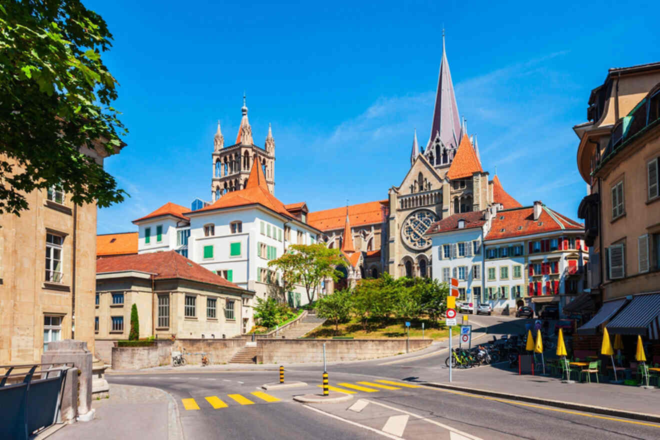 View of Lausanne Cathedral with surrounding buildings in Lausanne, Switzerland, on a clear day.