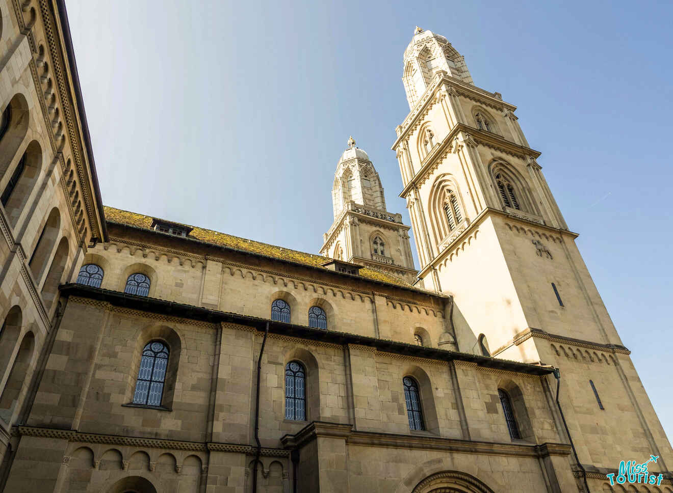 Exterior view of a historic cathedral with two tall towers under a clear blue sky.