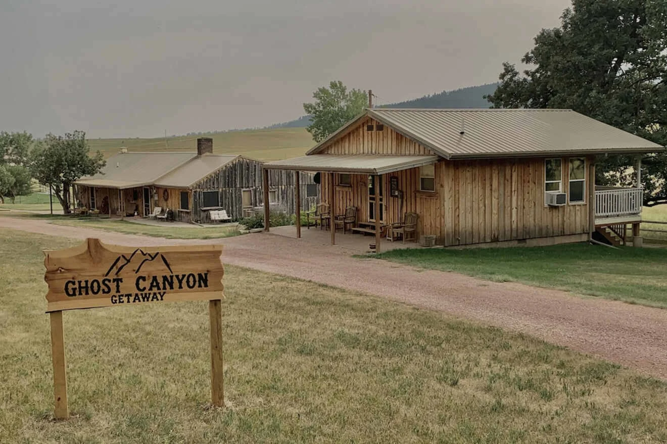 A wooden house with a sign in front of it.