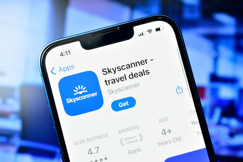 Close-up of a smartphone screen displaying the Skyscanner app page on an app store, showing ratings and age suitability.