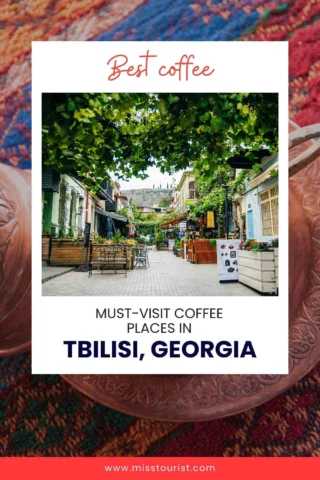 A charming street in Tbilisi, Georgia, lined with cafes and greenery, with a banner promoting the best coffee spots in the city.