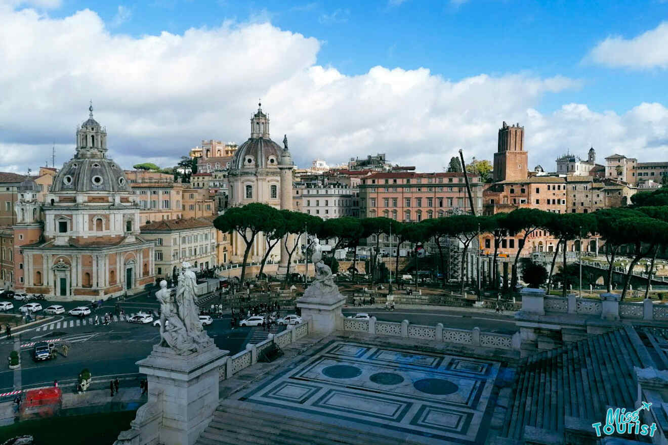 View of a historical cityscape with domed buildings, a busy street, and trees lining the road under a partly cloudy sky.