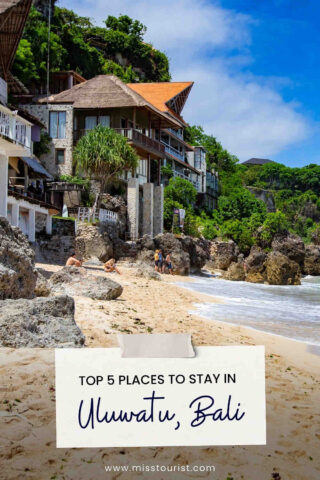 Beachfront scene with rocky shoreline, houses on a hillside, and several people relaxing on the sand. Text reads "Top 5 Places to Stay in Uluwatu, Bali.