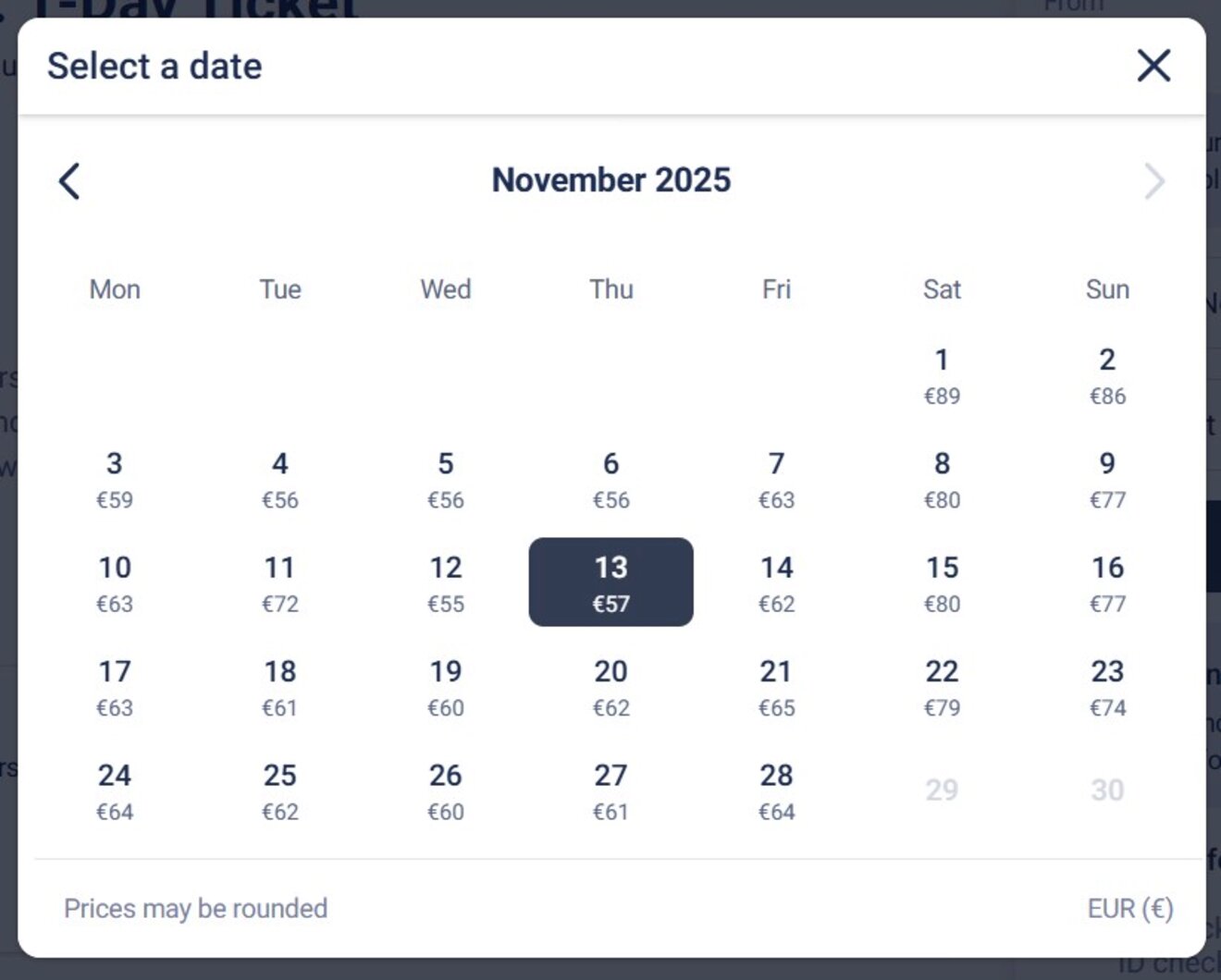 Calendar interface showing November 2025 flight prices. Selected date is November 13 with a price of €57. Prices vary from €210 on November 29 to €56 on November 26.