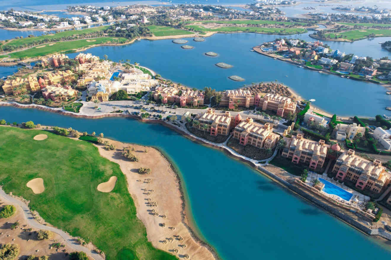 Aerial view of a resort with buildings surrounded by water, green landscaping, and several islands.