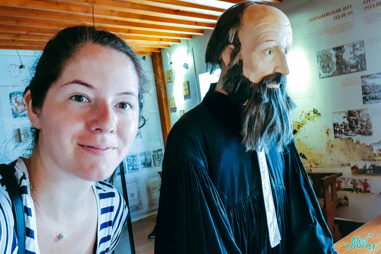 The writer of the post takes a selfie with a bearded wax figure in a museum setting.