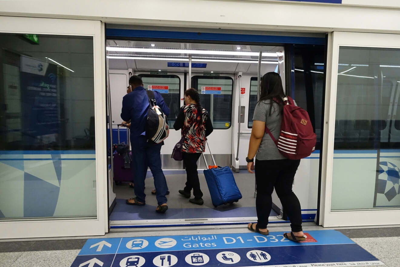 Passengers with luggage board a metro train.