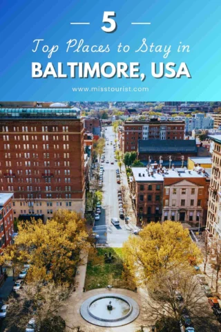 Aerial view of Baltimore cityscape with a park and fountain in the foreground, framed by brick buildings and a street lined with trees. Text overlay promotes top places to stay in Baltimore, USA.