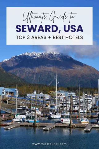 Marina in Seward, USA with boats docked and a mountain in the background. Text overlay: 