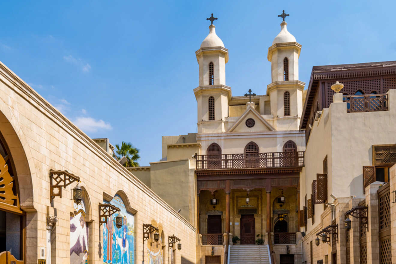 The image shows the Hanging Church in Cairo, featuring twin bell towers, ornate wooden balconies, and religious artwork on the walls.