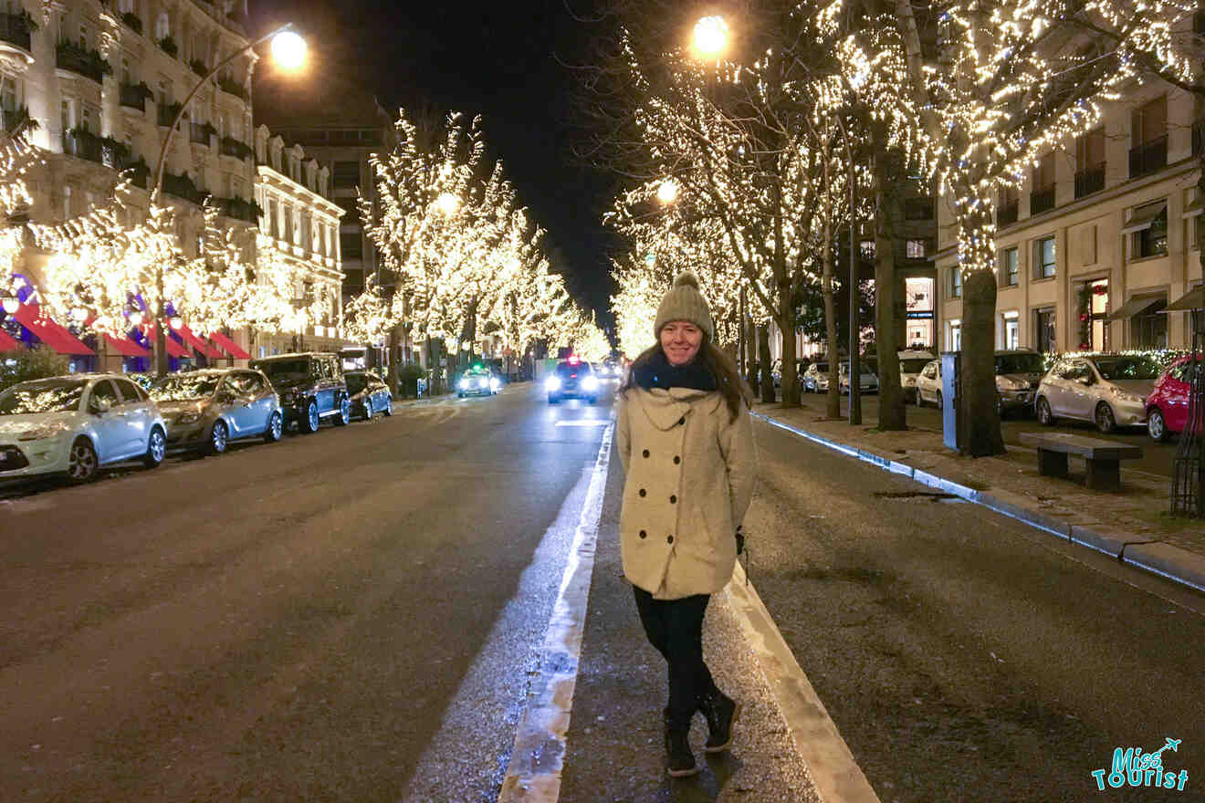 The writer of the post stands smiling on a city street at night, surrounded by trees adorned with festive lights.