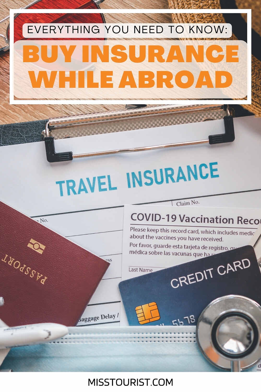 A clipboard with a travel insurance form, passport, credit card, COVID-19 vaccination record, and a luggage tag, emphasizing the importance of buying insurance while abroad.
